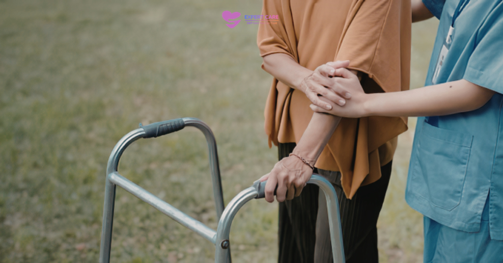 Trained carer providing mobility support during 24-hour care at home