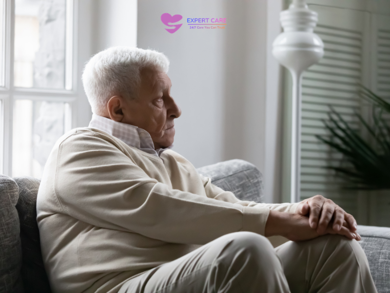 elderly person sitting alone by window